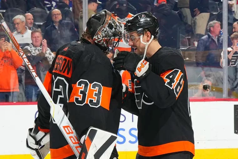 Samuel Ersson #33 of the Philadelphia Flyers celebrates with Morgan Frost #48 after the game against the Toronto Maple Leafs at the Wells Fargo Center on March 19, 2024 in Philadelphia, Pennsylvania.