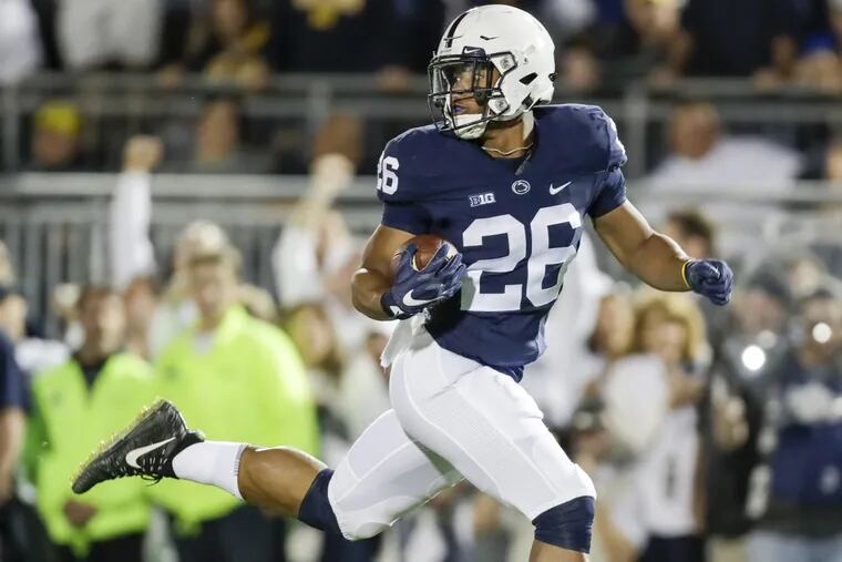 Penn State running back Saquon Barkley looks back running for a 69-yard first-quarter touchdown against Michigan on Saturday.