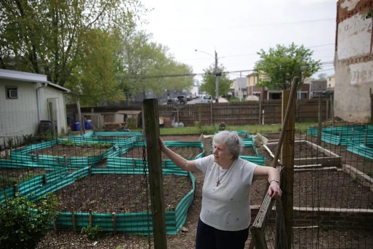 Sister Margaret McKenna rests next to her garden at the New Jerusalem Now food pantry in North Philadelphia.