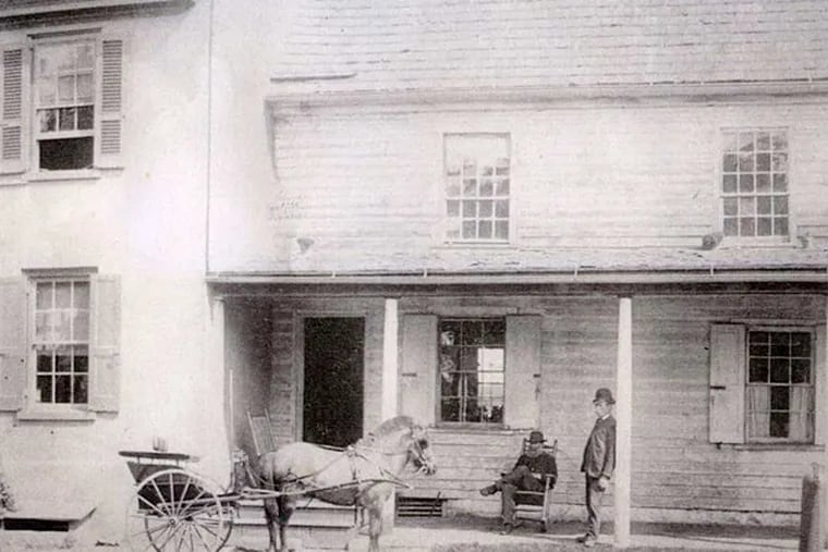 Andrew McNeal sits in a rocking chair on the porch of what could be Jegou's Tavern in a photograph from about 1890.