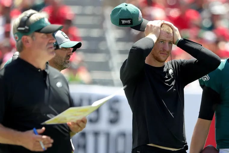 Carson Wentz watches as the Eagles struggle early in Sunday's loss to the Bucs.