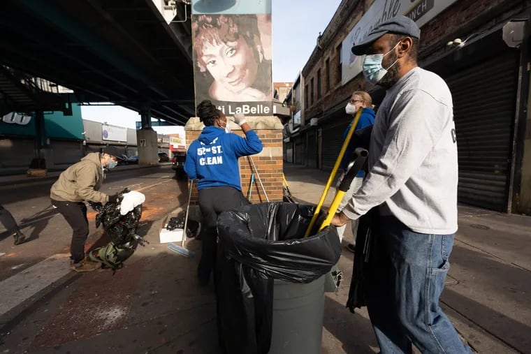 Community members clean up damage and vandalism on 52nd Street today in West Philadelphia, June 01, 2020. Destruction of property, violence, and theft occurred in Philadelphia on Saturday and Sunday after protests over the police involved death of George Floyd in Minneapolis.