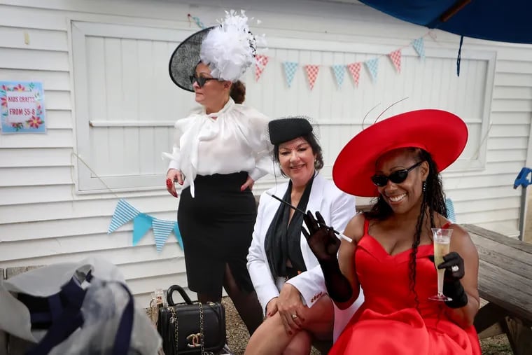 Tawana Tonkins (right), of Sewell, N.J., relaxes at a table during the Ladies Day Hat Contest at the Devon Horse Show.