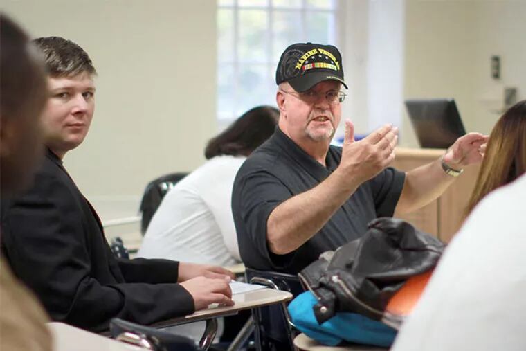 Veteran Jim Ulinski, center, and others in the Student Veterans of America chapter at Penn State Abington are organizing a Veterans Day panel aiming to increase understanding between vets and nonveteran students. (DAVID SWANSON / Staff Photographer)