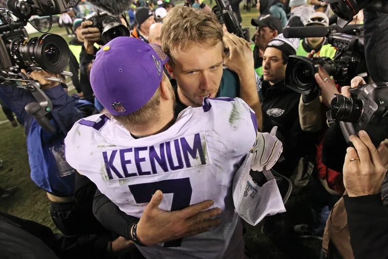 Eagles quarterback Nick Foles, right, embraces Minnesota quarterback Case Keenum , left, after the Eagles victory in the NFC championship game.