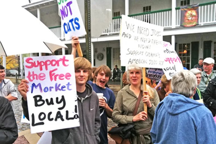 At Occupy Doylestown are (from left) protesters Mike Forgeng and Mike Jess of Central Bucks High South and Sandy Becker, 56, of Doylestown.