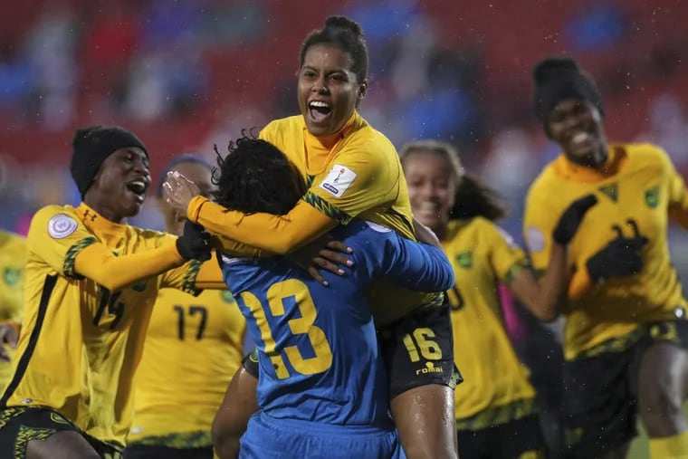 Deneisha Blackwood (14) and Nicole McClure (13) celebrate the winning penalty kick by Jamaica defender Dominique Bond-flasza (16) that beat Panama in the third place match of the CONCACAF women's World Cup qualifying tournament.