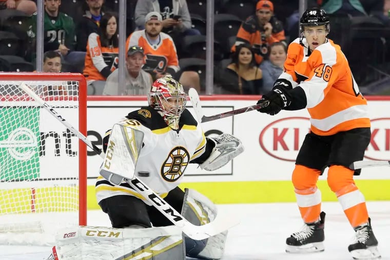 Flyers central Morgan Frost, shown trying to deflect the puck past Boston Bruins goalie Maxime Lagace during a preseason game, will make his NHL debut Tuesday in Florida.