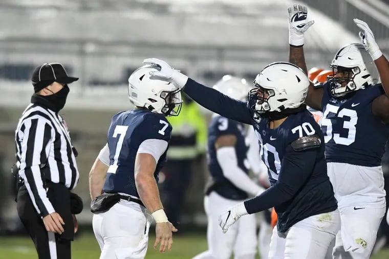 Penn State quarterback Will Levis (7) celebrates with Juice Scruggs (70) after scoring a touchdown against Illinois on Saturday.