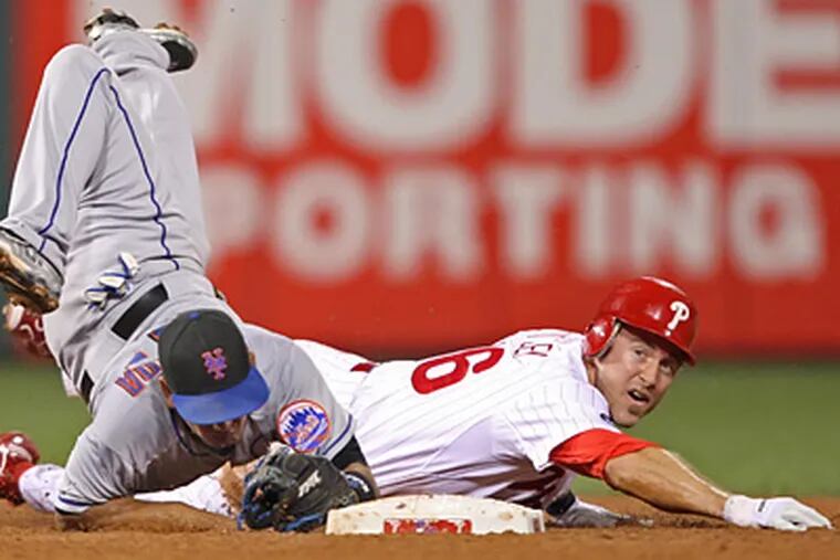 Chase Utley goes hard into second base trying to break up a double play against the Mets Friday. (Michael Bryant / Staff Photographer)
