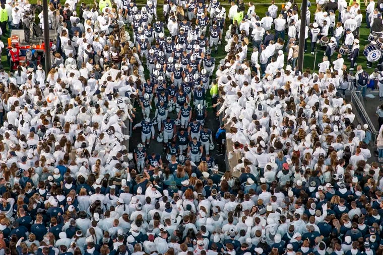 Fans cheer as the Penn State football team goes back to the tunnel before the start of last year's "White Out" game against Michigan at Beaver Stadium. No fans will be allowed in the stands this season because of Gov. Tom Wolf's restrictions on large crowds.