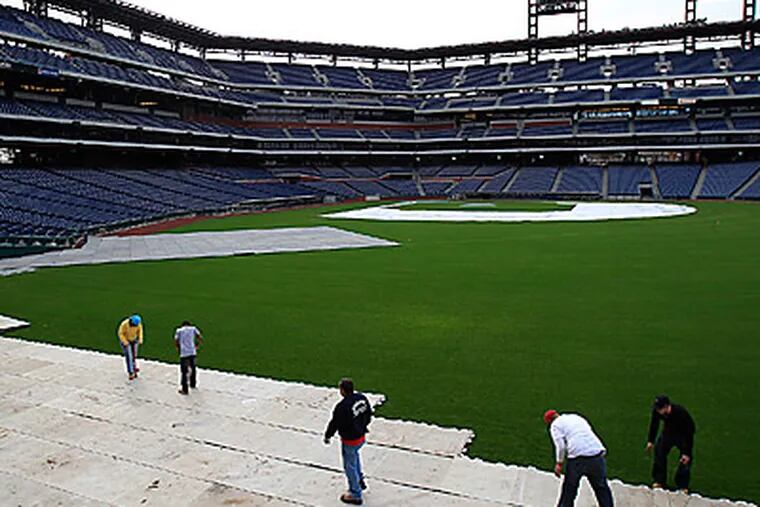 Workers start installing the decking system for the 2012 Winter Classic at Citizens Bank Park. ( David Maialetti  / Staff Photographer )