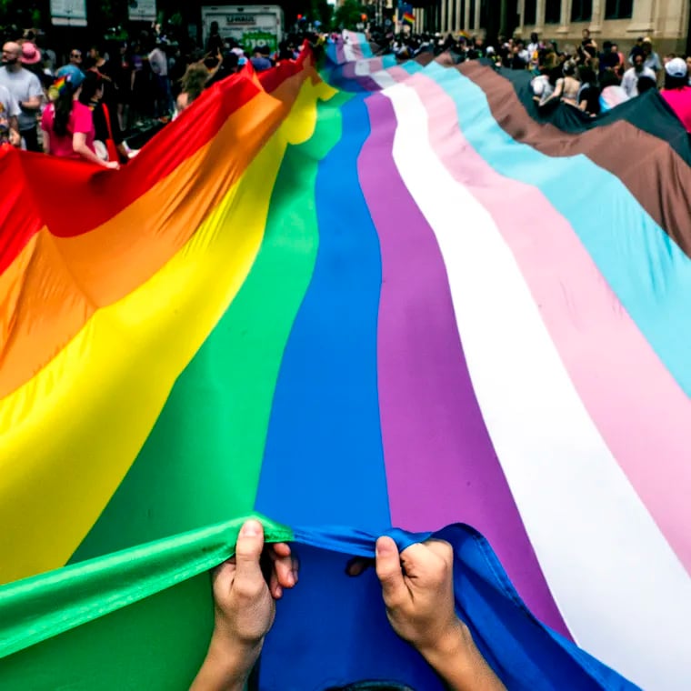 Marchers carry a 400-foot-long rainbow flag - the largest in Philadelphia history - moving it up Walnut Street as Pride March and Festival kicks off with a march from Washington Square on Sunday with the theme, “Be You.”