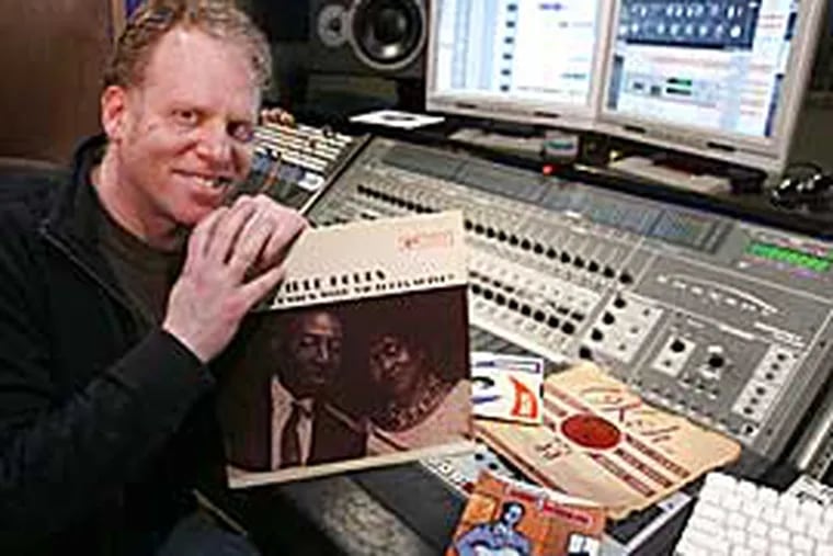 Blues guitarist Lonnie Johnson is the subject of a tribute album featuring Philadelphia musicians that has been produced by Aaron Levinson. He is shown with some of his Lonnie Johnson records in Range Recording Studio in Ardmore. (Charles Fox / Inquirer)
