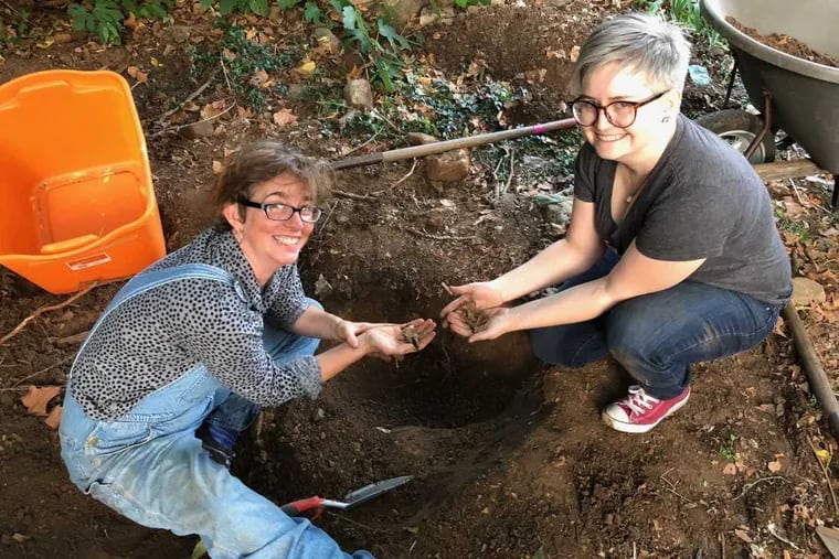 Alexis Buss, at left, and Rachael “Ru” Upton, at right, with groundhog bones they found during their Saturday dig.
