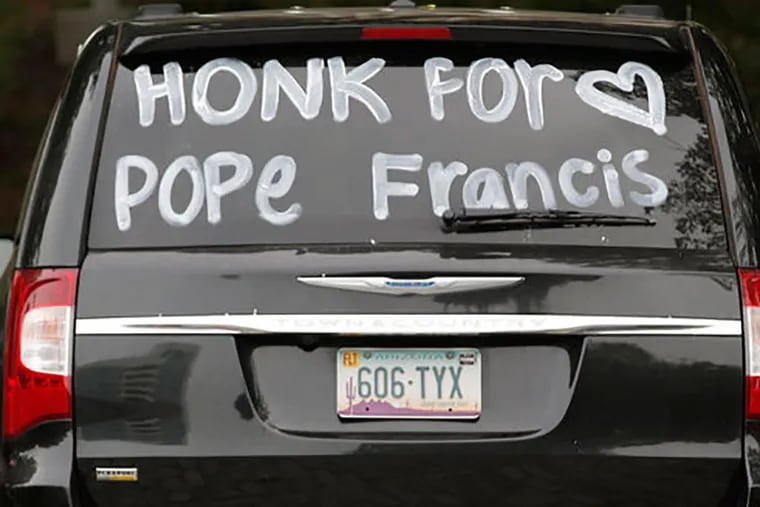 "Honk For Pope Francis" on the back of a car with Arizona plates parked on 2nd St. on Sept. 25, 2015.  ( CHARLES FOX / Staff Photographer )