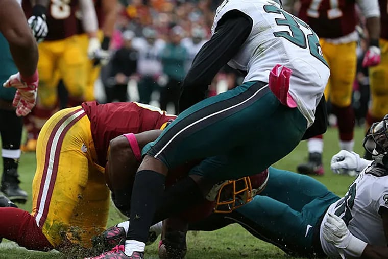 The Redskins' Pierre Garcon (left) scores the game-winning touchdown as Eric Rowe and Walter Thurmond try to defend.