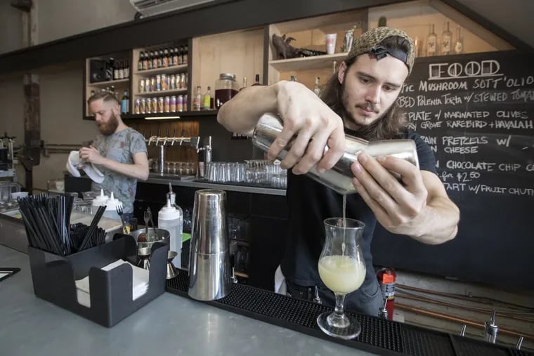 Bar manager Josh Dressel mixes up the Brewhaze from Dock Street Cannery.
