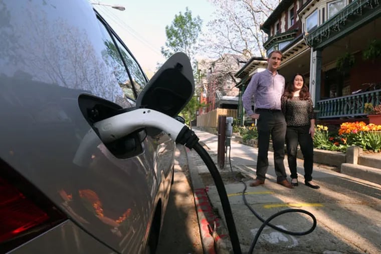 Jaap Veneman and his wife, Sarah Shackley, top, who recently installed a curbside charger for their Volkswagen e-Golf. The cost is upward of $4,000, including PPA permits. But soon, the parking is all theirs. ( DAVID SWANSON / Staff Photographer )