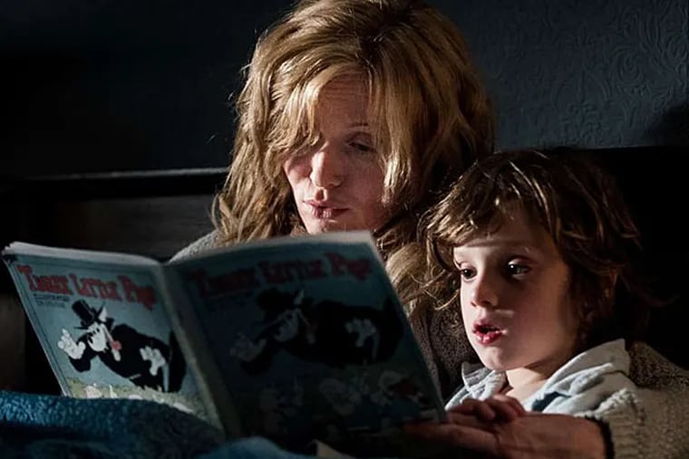 Curling up with a good book: Essie Davis and Noah Wiseman in the Australian horror film "The Babadook." (IFC Midnight)