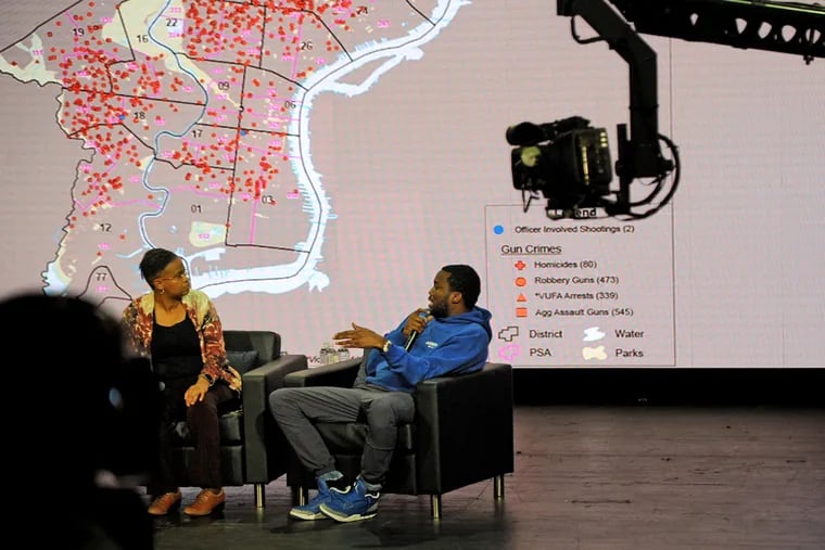 A map of gun crimes in Philadelphia is projected behind them as rapper Meek Mill (right) and Rev. Leslie D. Callahan (left), pastor at St. Paul's Baptist Church, participate in a public forum to get input on what the community of Philadelphia wants from its new Police Commissioner, at Community College of Philadelphia October 28, 2019. The town hall meeting was hosted by The NFL Players Coalition, a nonprofit co- founded by Eagles Malcolm Jenkins (not shown).