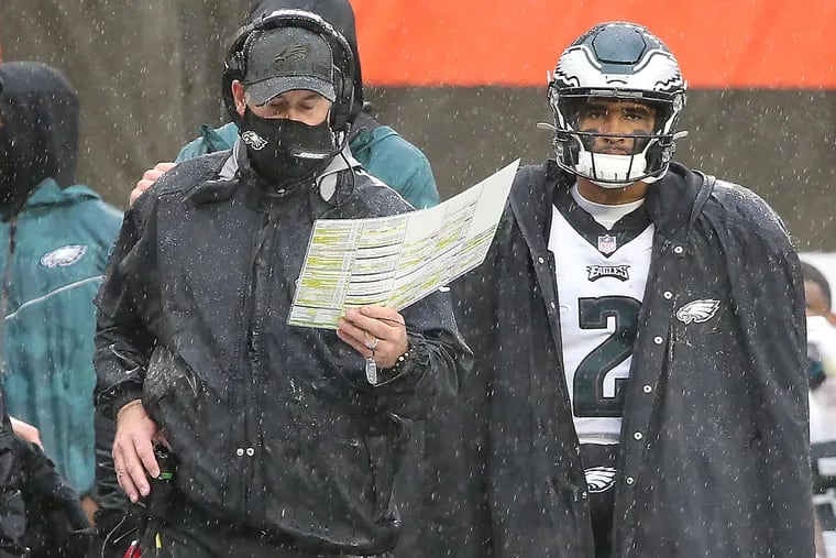 Eagles head coach Doug Pederson (left) shut down the question of whether Jalen Hurts (right) should start over Carson Wentz after Sunday's 22-17 loss to the Browns.