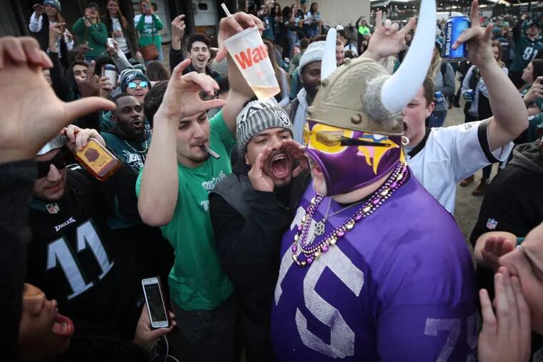 Vikings fan Andrew Grein walked through a crowd of hostile Eagles fans before kickoff of the NFC Championship Game at Lincoln Financial Field in Philadelphia on Sunday.