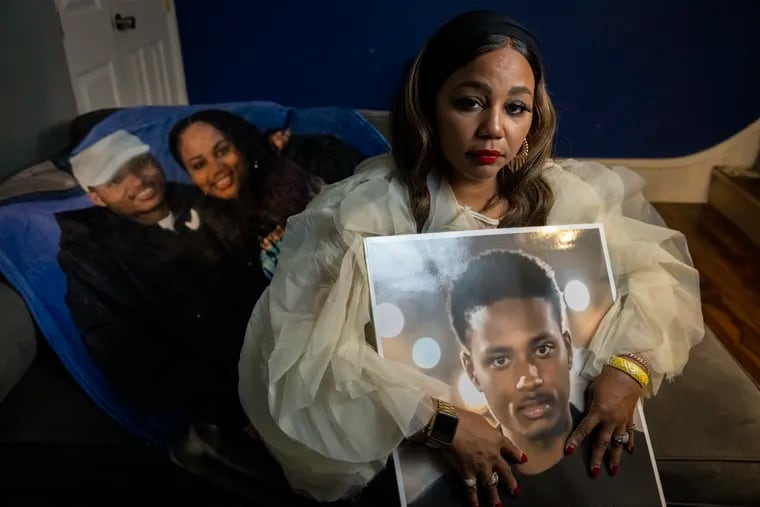 Corliss Jackson, mother of Rasheen Naseeb Robinson, 22, who was fatally shot March 22, 2022, at a Liberty gas station in East Kensington. Photograph taken at her home Nov. 11, 2022, with a portrait of Rasheen.