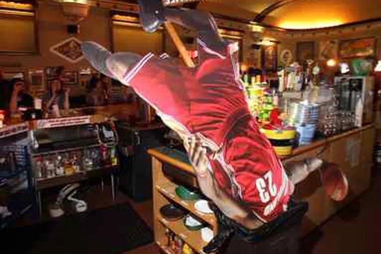 A cardboard standup of LeBron James is consigned to the wastebasket in this Cleveland restaurant after James announced he was going to Miami.