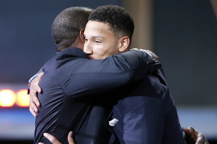 Proud father Dave Simmons (left) hugs his son Ben, who was selected first overall by the Sixers.