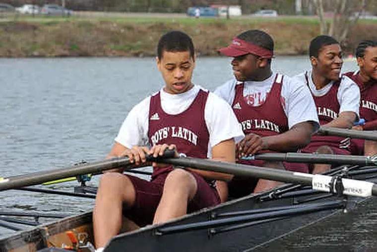 Out on the Schuylkill: Four Boys’ Latin of Philadelphia Charter School rowers — (from left) Jerell Maddrey, Brian Solomon, Eric Young, and Jared Smith — head for the start line at the April 19 Manny Flick regatta. Their boat, the Darth Vader, finished second in the race, their first competition.