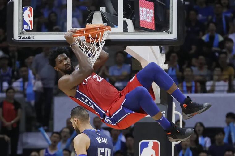 Joel Embiid dunks for two of his 29 points against the Dallas Mavericks.