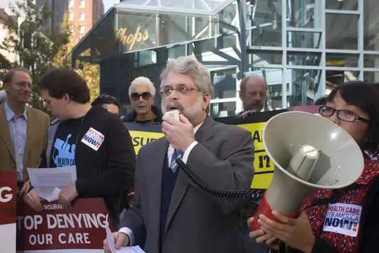 Marc Stier (center) leads a protest outsideCigna Corp. headquarters. Stier, whowas arrested for refusingto move, isan officialof the group Health Care for America Now.