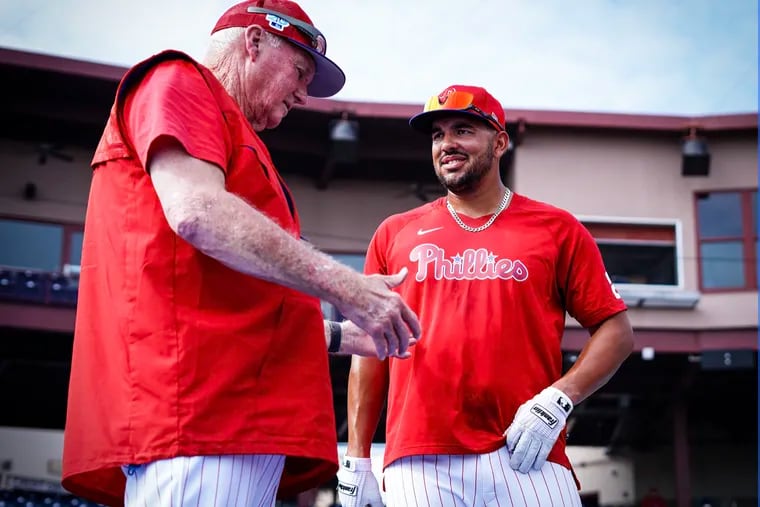Former Phillies manager Charlie Manuel talks with Darick Hall on Saturday.