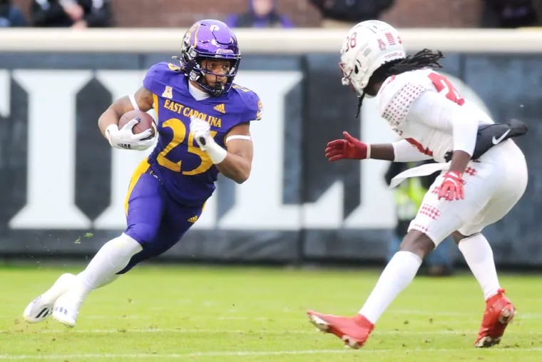 East Carolina's Keaton Mitchell (25) runs the ball against Temple's Jalen Ware (38) during Saturday's game.