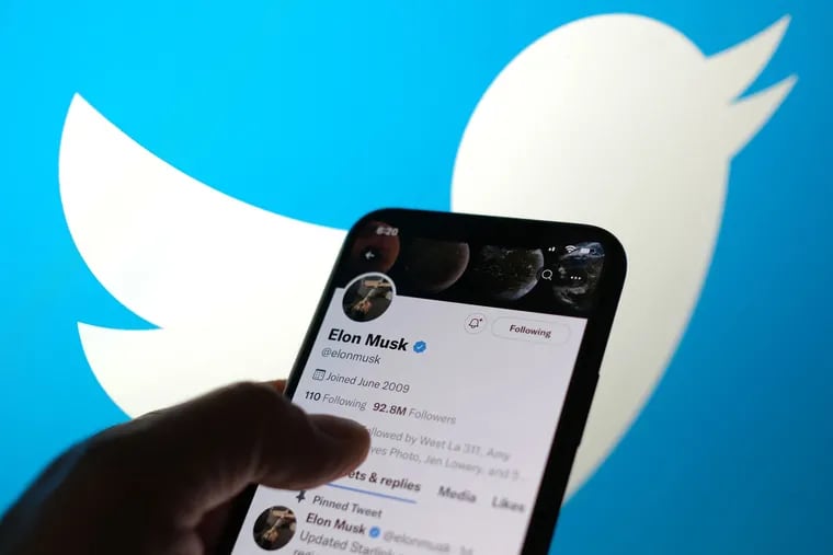 This illustration photo displays Elon Musks Twitter account with a Twitter logo in the background