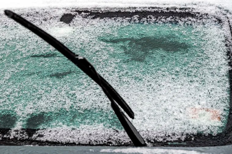 The snow on a car windshield has turned to ice in Port Richmond Tuesday, Jan. 16. 2024 after the region’s historic snowless streak ended on the 716th day.