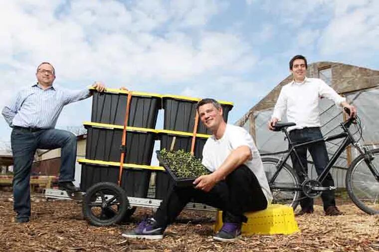 From left to right, Andy Klibanoff, of Sun and Earth Products, Dylan Bard, of Neighborhood Foods and Gabriel Mandujano, of Was, Cycle and Laundry at the Neighborhood Foods Farm at 602 N. 53rd Street. The containers on the back of the trailer will be used to carry the food and products.    A pedal-powered laundry entrepreneur featured sometime ago in Small Business joins with other local green-business owners to offer locally grown foods delivered by bicycle.:	Please get a photo of Gabriel Mandujano and his two partners on the partners' farm, with bikes they will use for delivering locally grown food. 04/16//2013 ( MICHAEL BRYANT / Staff Photographer  )