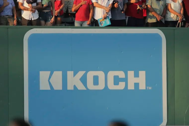 An advertising sign for Koch Industries is shown at Fenway Park in Boston in 2019.