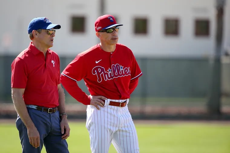 Phillies owner John Middleton (left) talks with manager Joe Girardi during spring training in Clearwater, Fla., in February.