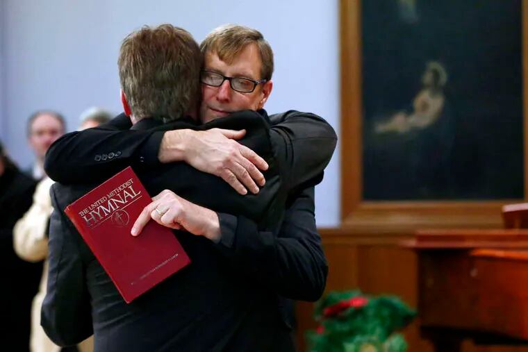 ASSOCIATED PRESS The Rev. Robin Hynicka (right) embraces the Rev. Frank Schaefer during a news conference yesterday in Philadelphia.