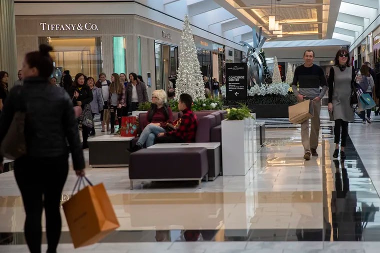FILE photo shows shoppers in the King of Prussia Mall. The mall's owner Simon Property Group is joining Conshohocken-based Michael Rubin, who owns online sportswear leader Fanatics to start an online store for premium outlets.