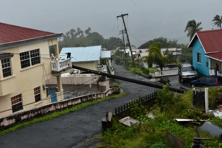 An electrical pole felled by Hurricane Elsa last year leans on the edge of a residential balcony in Florida. A storm forming in the Caribbean could take a path similar to Elsa's, forecasters say.
