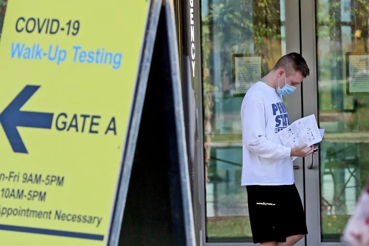 A Penn State student looks over test results after visiting the university's COVID-19  walk-up testing site at the Pegula Ice Arena in University Park on Oct. 21, 2020. Penn State is increasing COVID-19 testing for the spring semester