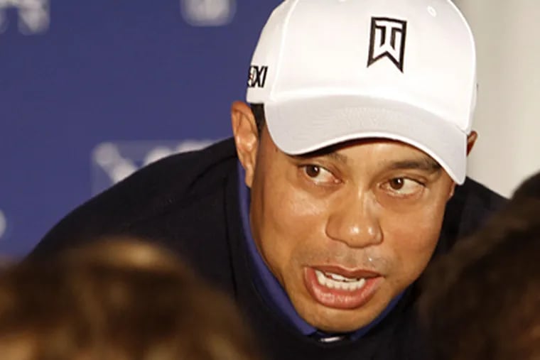 Tiger Woods answers questions during a news conference at the Farmers Insurance Open golf tournament. (AP Photo/Lenny Ignelzi)