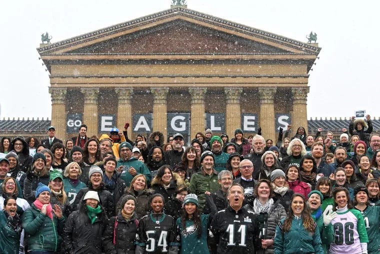 Philadelphia Museum of Art staffers and friends, chant “Fly Eagles Fly!” as they posed for pictures during the unveiling of an Eagles banner on the East Facade of the museum in Philadelphia. Tuesday, January 30, 2018.
