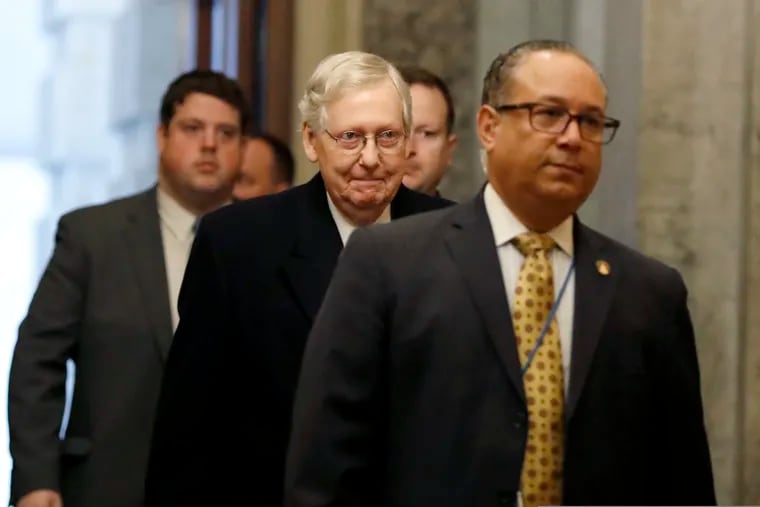 Senate Majority Leader Mitch McConnell of Ky., center, arrives at the Capitol in Washington during the impeachment trial of President Donald Trump on charges of abuse of power and obstruction of Congress, Friday, Jan. 24, 2020.