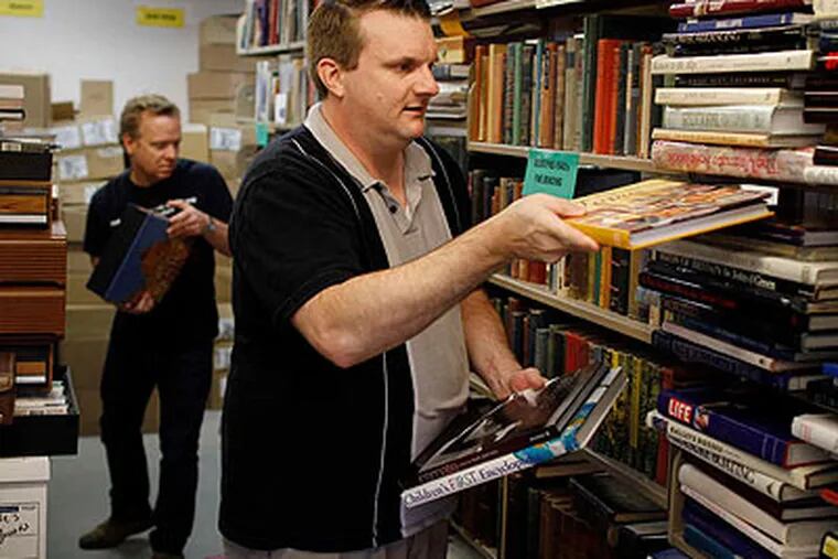 Voorhees library managers Chris Entwisla (left) and William Brahms organize a book sale - "good for the Earth and good for the libraries," said a book-sale veteran. (Michael S. Wirtz / Staff Photographer)