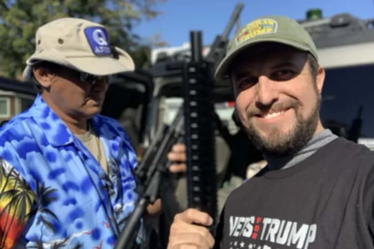 According to a court filing by the Philadelphia District Attorney, this photograph found on Joshua Macias' phone shows Antonio LaMotta (left) wearing a QAnon hat and Macias in a Vets for Trump shirt, holding AR-15-style assault rifles.