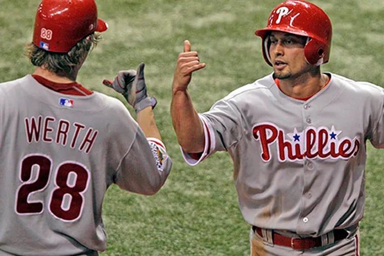 Shane Victorino is greeted by Jayson Werth after scoring on a Carlos Ruiz ground ball in the fourth inning of World Series Game 1 at Tropicana Field on October 22, 2008.